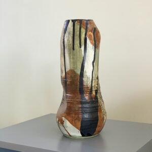 thrown adn hand bilt vase with brown glaze and coloured underglazes